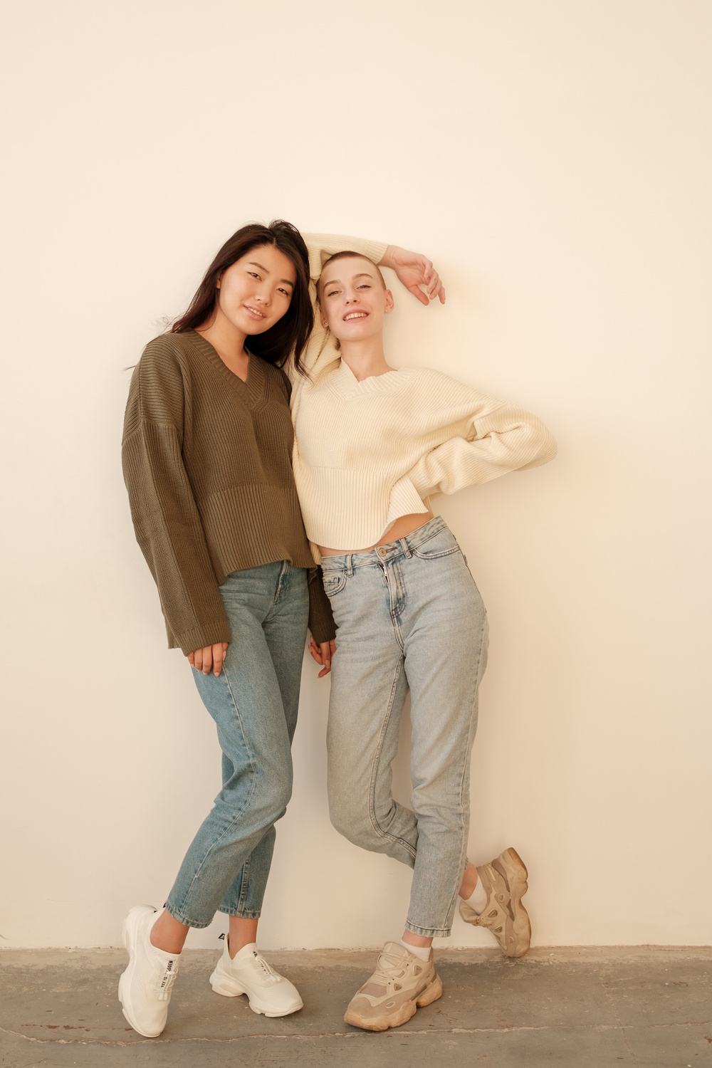 Two Female Friends Leaning against the Wall