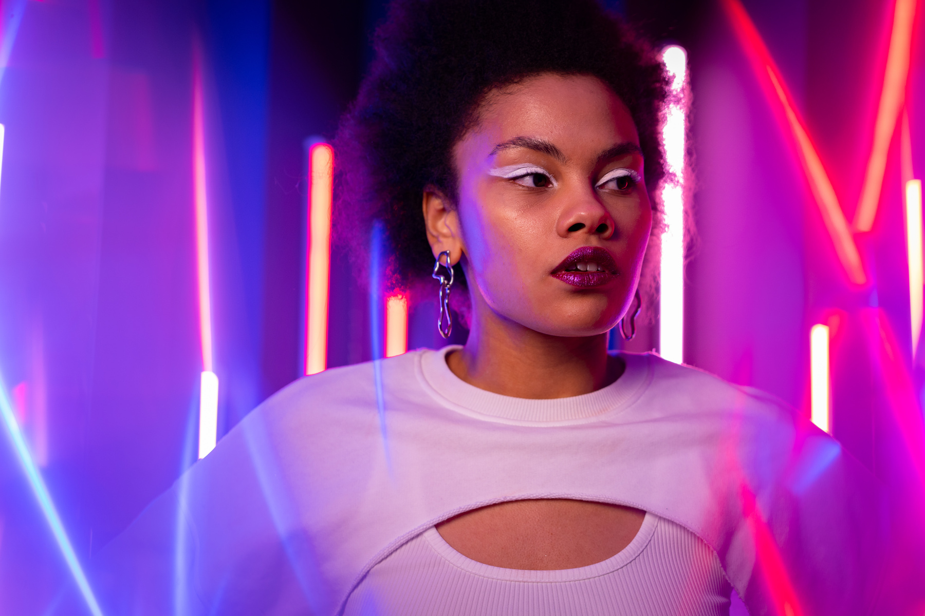 Portrait of Young Woman in Neon Light Background